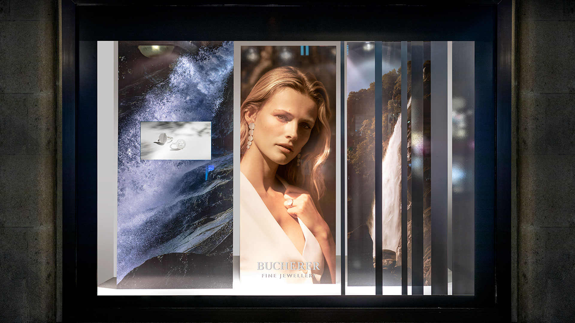 Bucherer Schaufenster mit Model und künstlerischen Wasserfallmotiven, entworfen von MORE PIOUS STUDIOS für POS & Window Campaign.