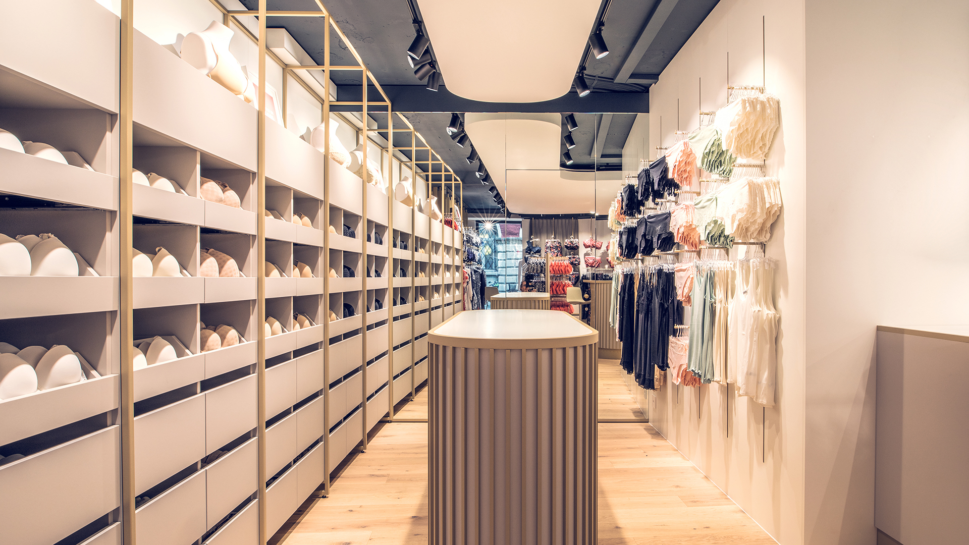 Gang mit BH- und Unterwäsche-Regalen in einem Beldona-Geschäft, entworfen von MORE PIOUS STUDIOS mit Fokus auf Visual Communication und Retail Design.