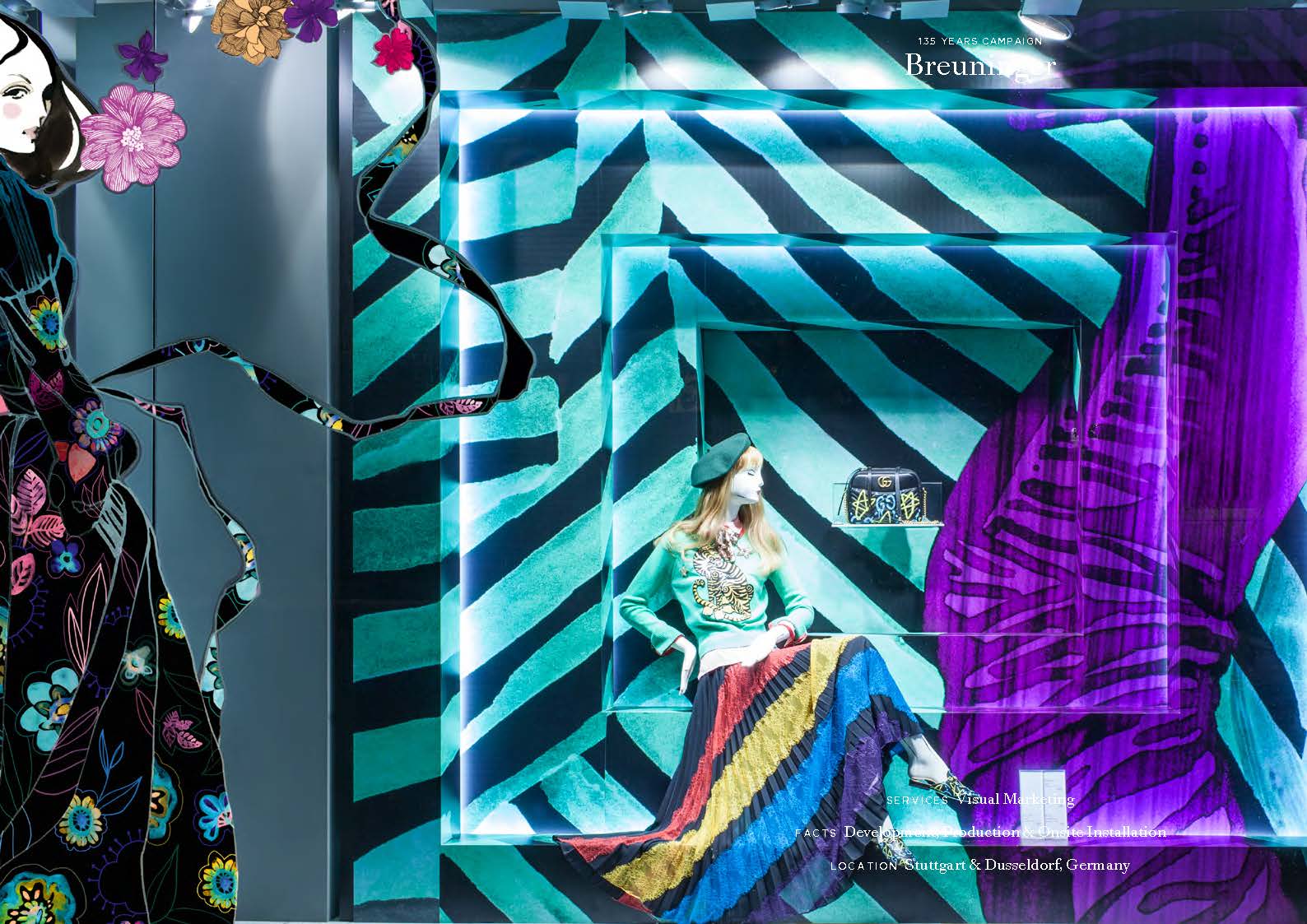 Kreativ gestaltetes Schaufenster mit geometrischem Hintergrund und modischer Präsentation bei Breuninger