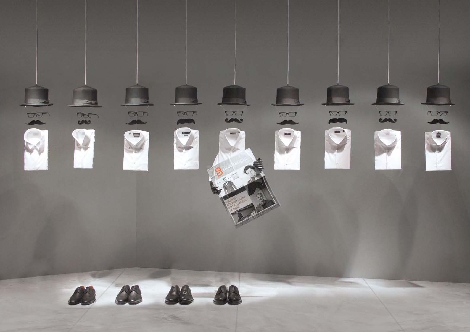 Kreatives Schaufensterdesign mit schwebenden Hemden und Accessoires, gestaltet von MORE PIOUS STUDIOS