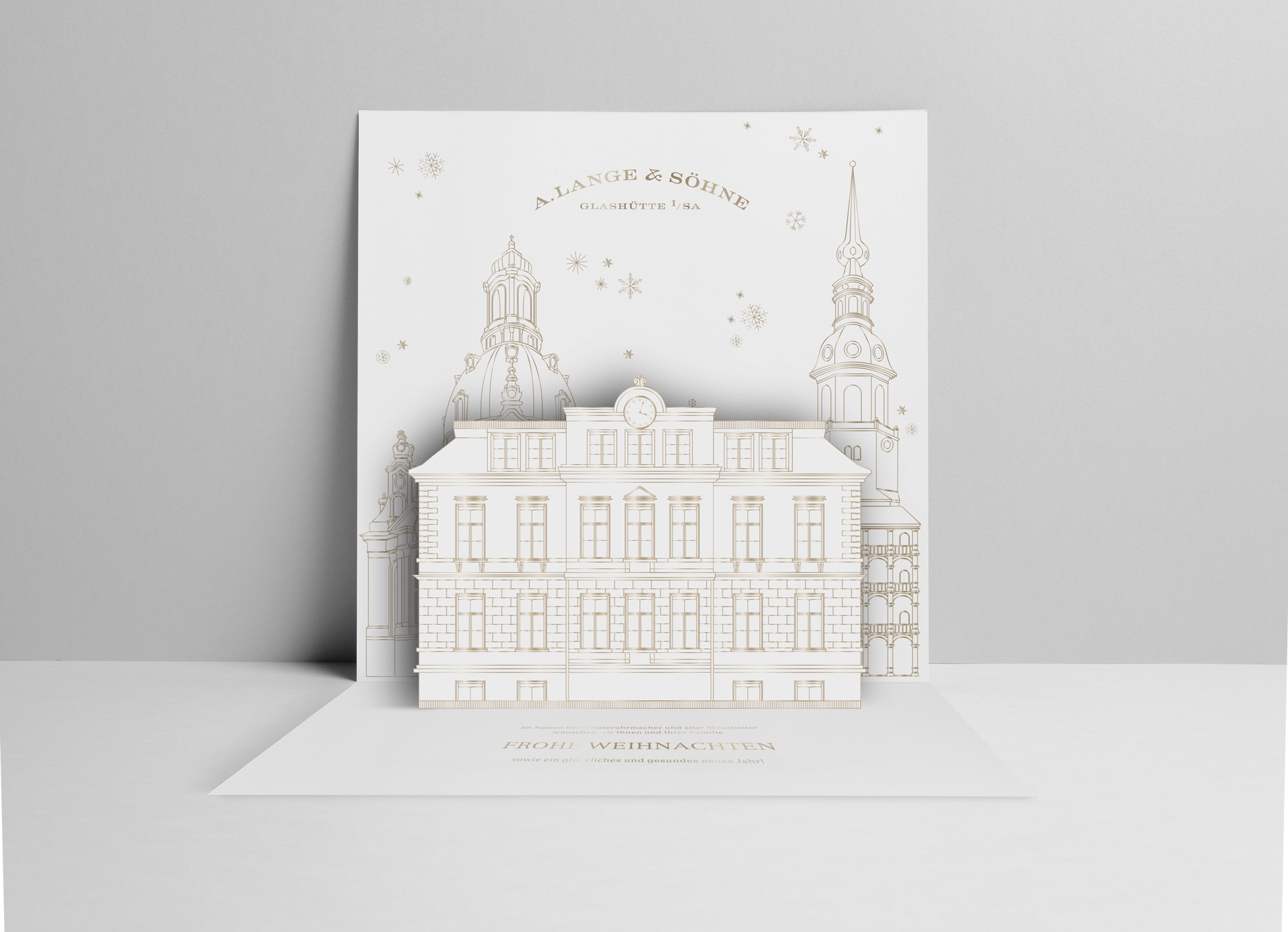 Pop-up-Weihnachtskarte von A. Lange & Söhne mit detaillierter Darstellung eines historischen Gebäudes, umgeben von stilisierten Türmen.